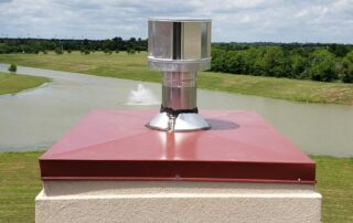 Chimney cap for prefabricated fireplace with red chase top.