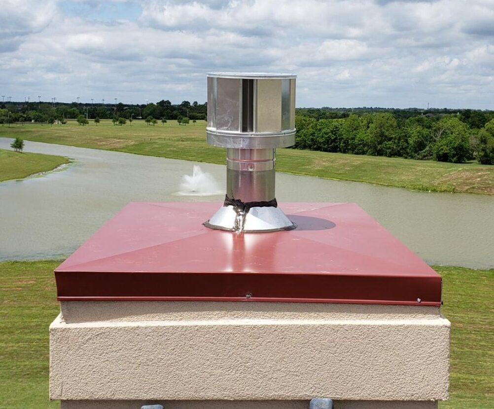 Chimney cap for prefabricated fireplace with red chase top.