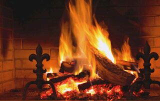 Close up image of wood burning in home's fireplace.